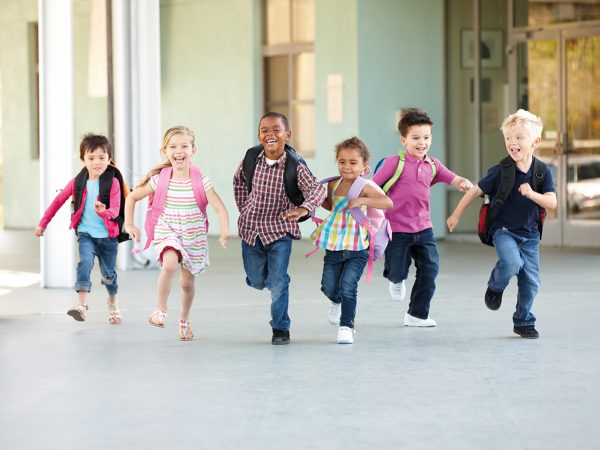Group Of Elementary Age Schoolchildren Running Outside Group Of Elementary Age Schoolchildren Running Outside